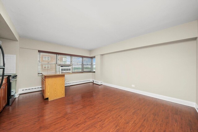 empty room featuring a baseboard radiator and dark hardwood / wood-style flooring