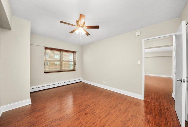 spare room featuring a baseboard radiator, dark hardwood / wood-style floors, and ceiling fan