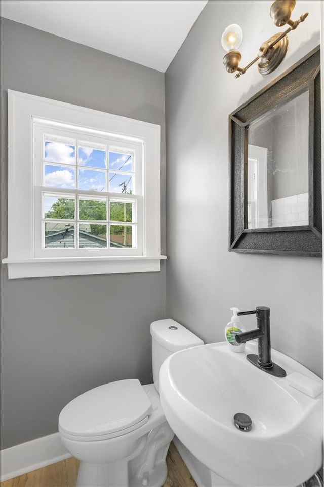 bathroom featuring hardwood / wood-style floors, sink, and toilet