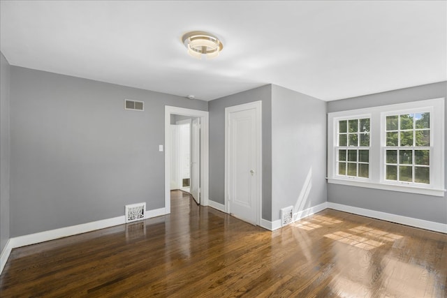 empty room featuring wood-type flooring