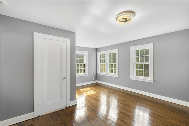 empty room with dark hardwood / wood-style floors