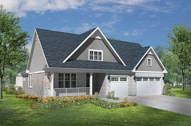 view of front of property featuring covered porch, a garage, and a front yard