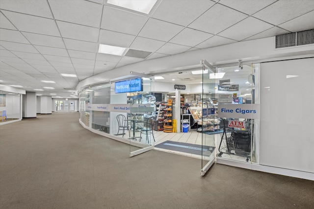 interior space with a paneled ceiling