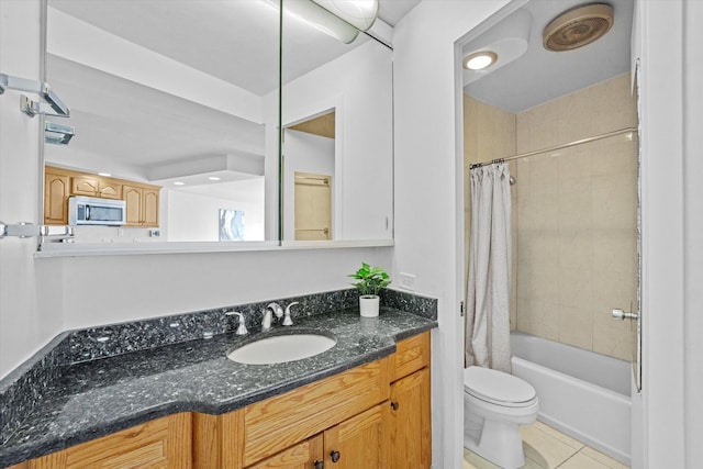 full bathroom with tile patterned flooring, toilet, shower / tub combo with curtain, and vanity