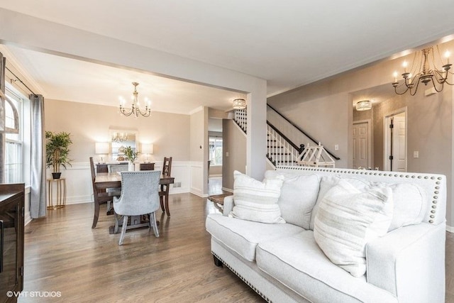 living room with hardwood / wood-style floors and an inviting chandelier