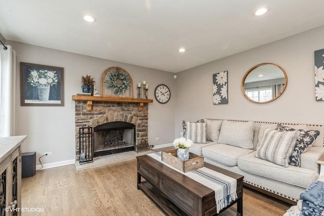 living room with a fireplace and light hardwood / wood-style flooring