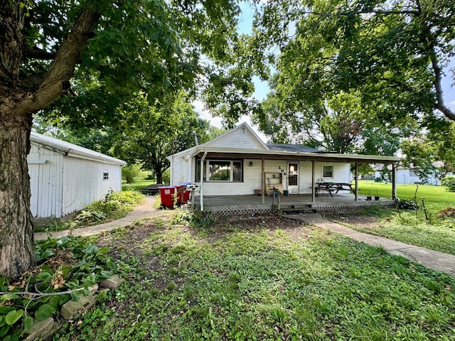 view of front of home with a porch and a front yard