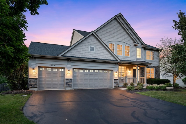 craftsman house with a garage and covered porch