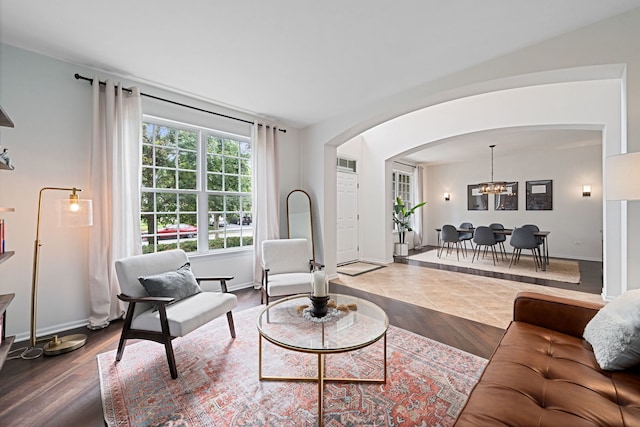 living room featuring dark hardwood / wood-style floors and an inviting chandelier