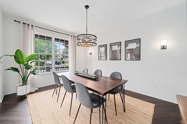 dining room featuring dark hardwood / wood-style floors and a chandelier