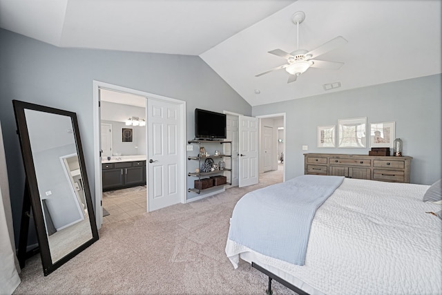 carpeted bedroom featuring ceiling fan, lofted ceiling, and ensuite bathroom