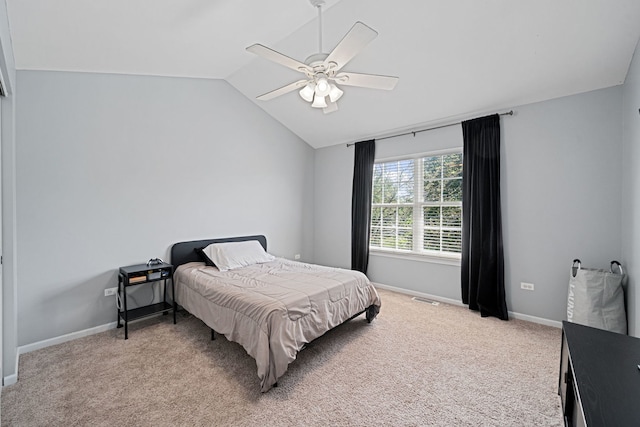 bedroom featuring ceiling fan, light carpet, and vaulted ceiling