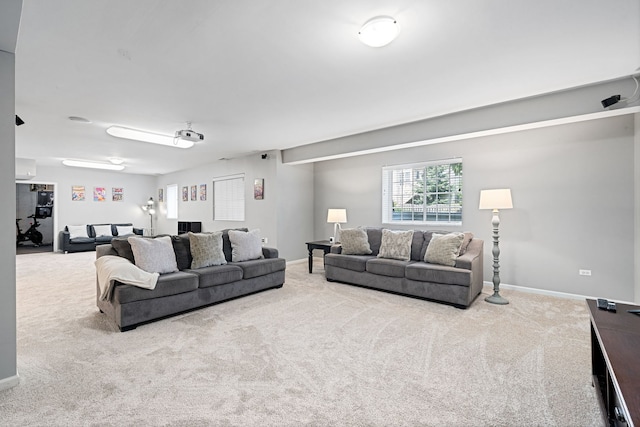 living room with an AC wall unit and light carpet