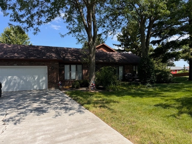 ranch-style house with a front yard and a garage