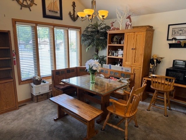 carpeted dining room featuring a notable chandelier