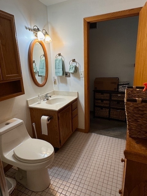 bathroom featuring vanity, toilet, and tile patterned floors