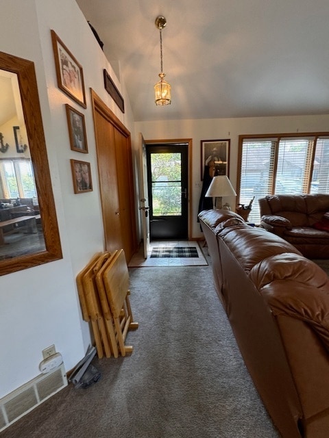 foyer entrance with lofted ceiling and tile patterned floors