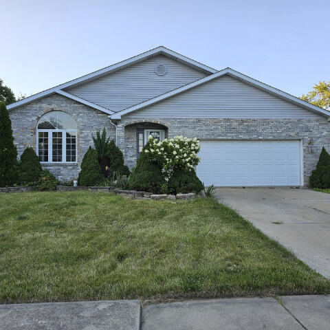 single story home with a garage and a front yard