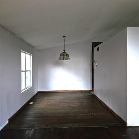 unfurnished dining area featuring dark hardwood / wood-style floors