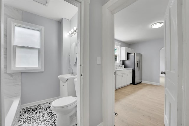 bathroom with vanity, hardwood / wood-style flooring, and toilet