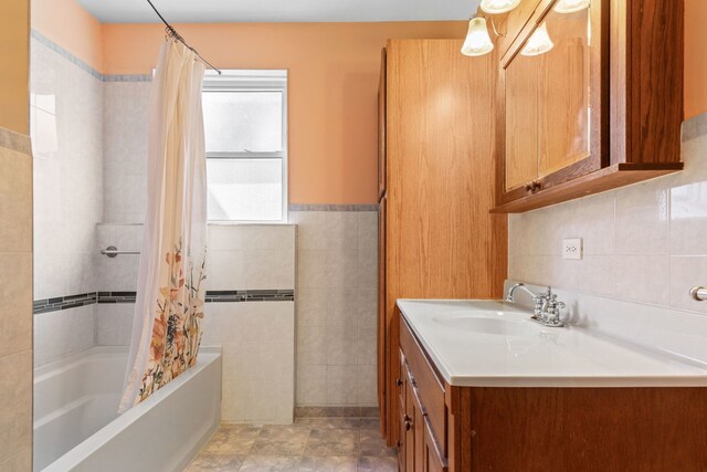 bathroom featuring tile patterned flooring, vanity, tile walls, and shower / bath combo