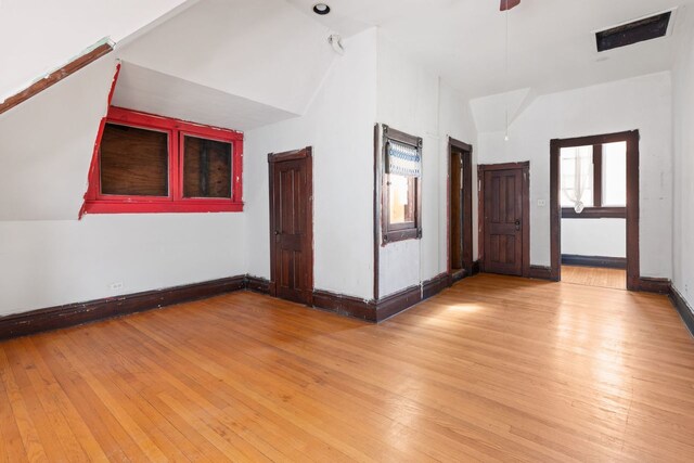 bonus room with vaulted ceiling and light hardwood / wood-style floors