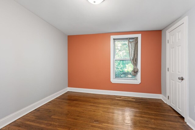 spare room featuring dark wood-type flooring