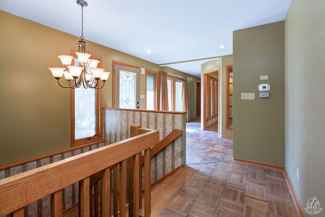 corridor with an inviting chandelier and a wealth of natural light