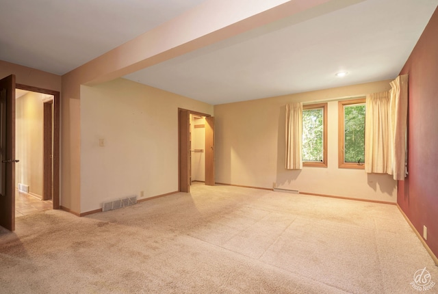 unfurnished room with light carpet