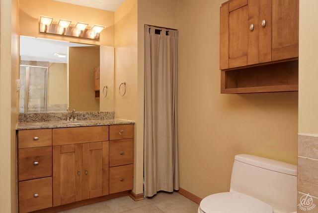 bathroom featuring tile patterned floors, walk in shower, vanity, and toilet