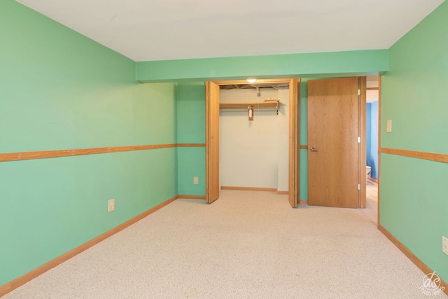 unfurnished bedroom with light carpet and a closet