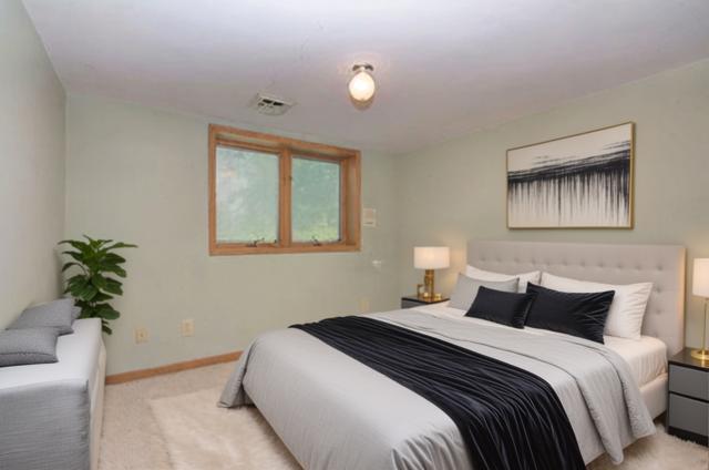 bedroom with light colored carpet