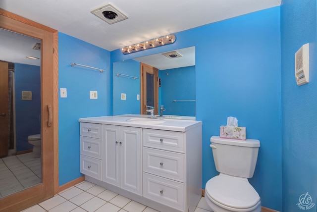 bathroom with tile patterned floors, vanity, and toilet