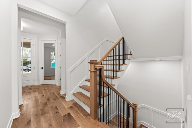 stairs featuring wood finished floors