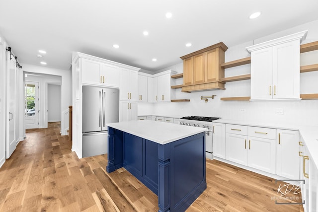 kitchen with open shelves, appliances with stainless steel finishes, white cabinets, and light countertops