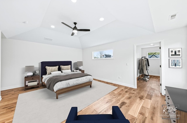 bedroom featuring visible vents, lofted ceiling, and light wood-type flooring