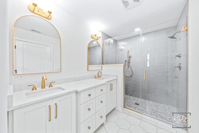 full bathroom with visible vents, a sink, a stall shower, and double vanity