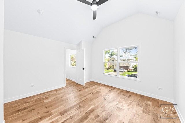 empty room with light wood-style floors, baseboards, a ceiling fan, and lofted ceiling