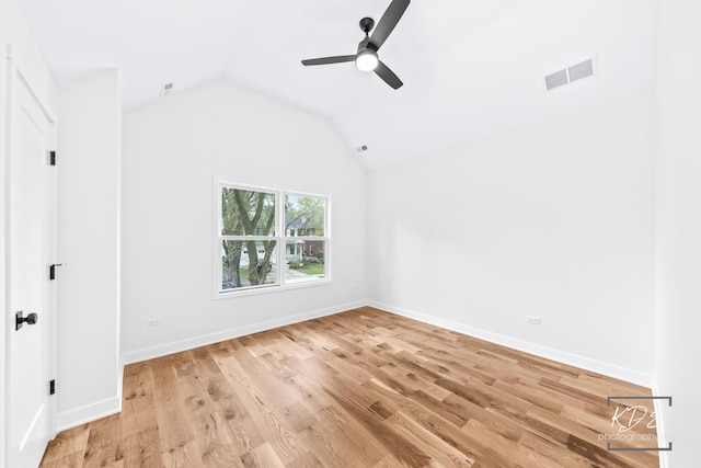 unfurnished room featuring a ceiling fan, visible vents, baseboards, lofted ceiling, and light wood-style floors