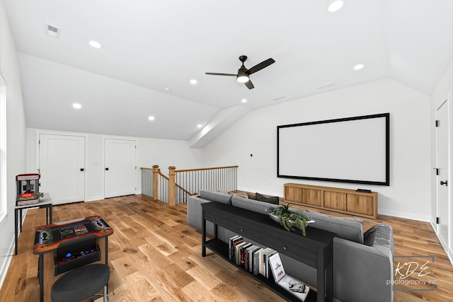 cinema room with ceiling fan, visible vents, recessed lighting, light wood-type flooring, and vaulted ceiling