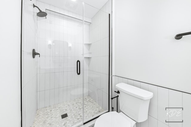 full bathroom with a stall shower and toilet