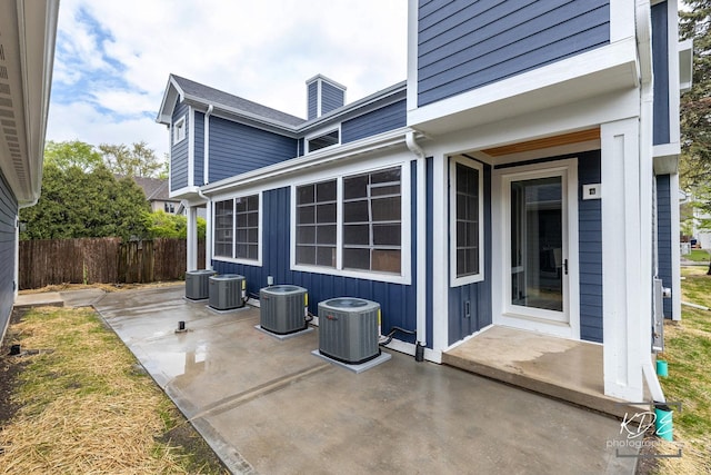 exterior space featuring central air condition unit and fence