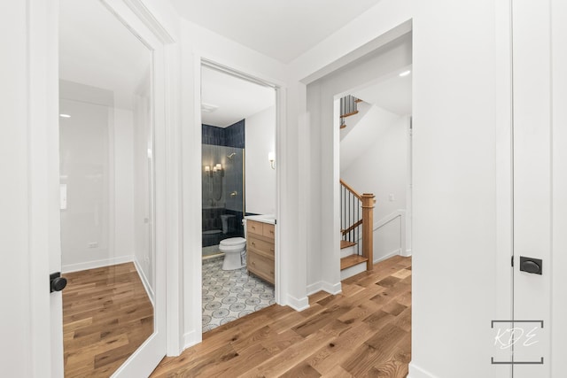 hall featuring light wood-style floors and stairway