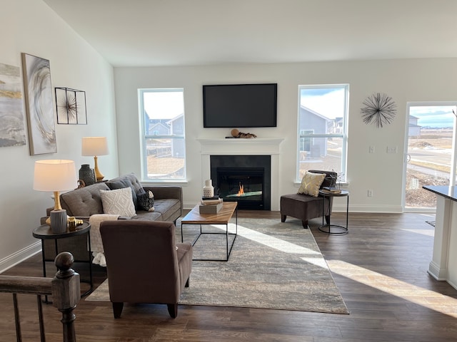 living room featuring dark hardwood / wood-style floors and plenty of natural light