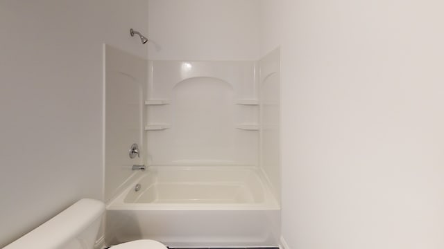 bathroom featuring washtub / shower combination and toilet