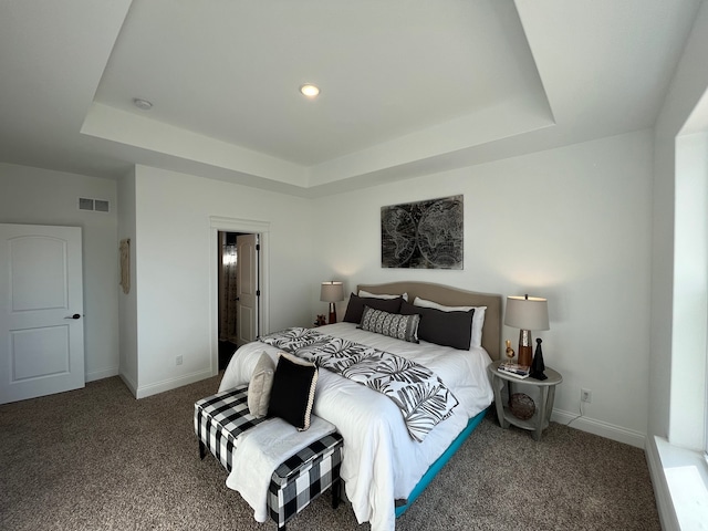 bedroom featuring carpet, connected bathroom, and a raised ceiling