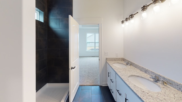 bathroom with double vanity and tile patterned floors