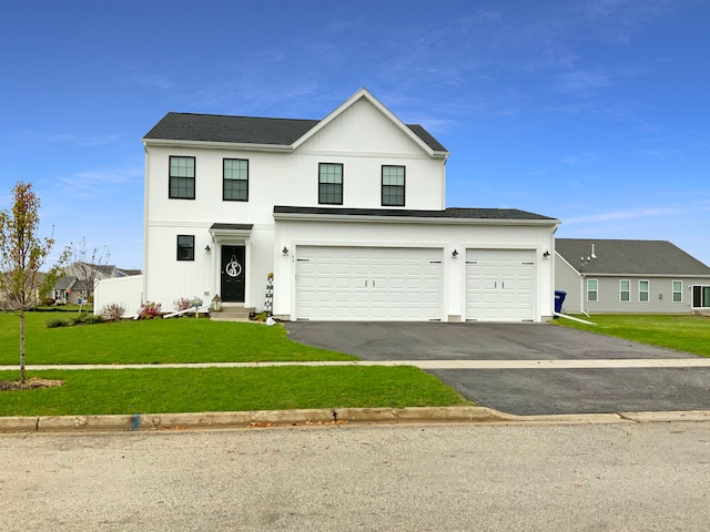 view of front of property with a garage and a front yard