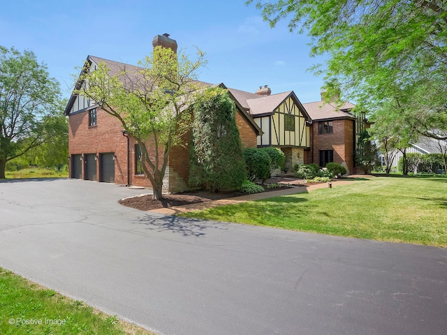 view of front of home featuring a garage and a front lawn