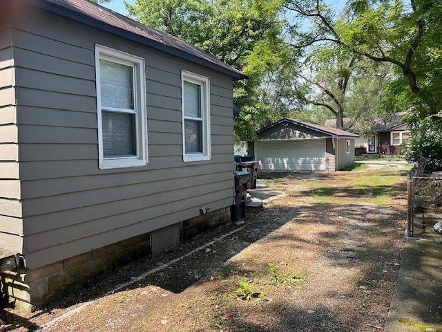 view of side of property with a garage and an outdoor structure